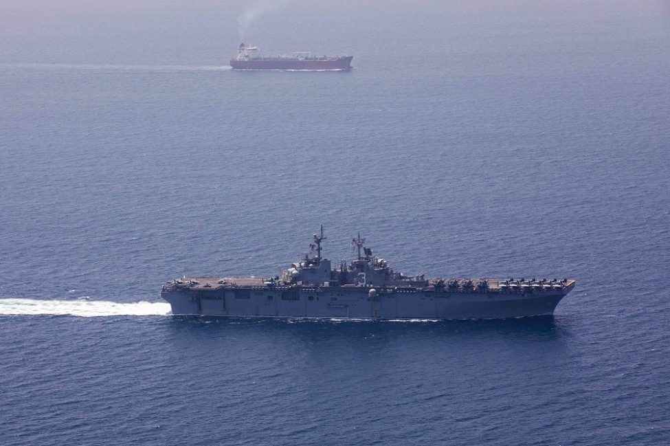 Warship and tanker transit the Strait of Hormuz
